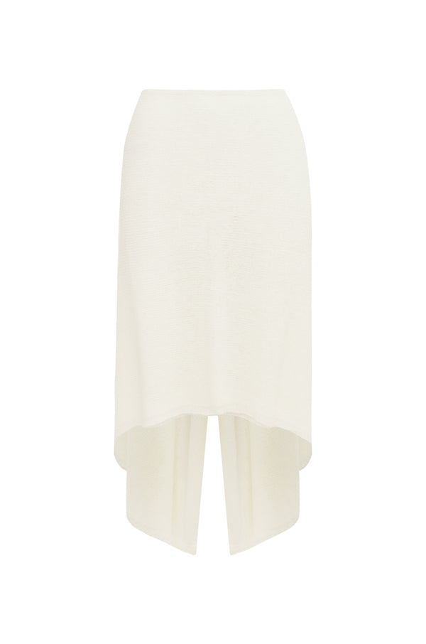 Ivory knit midi skirt with a V-back and draped, asymmetrical hem, shown against a plain white background.