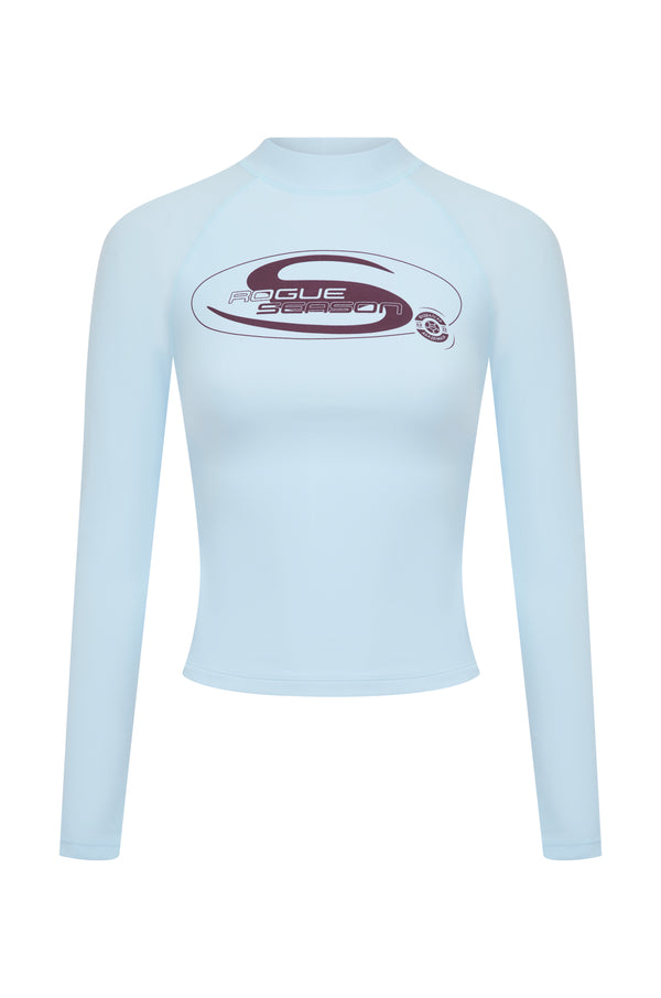 A baby blue long-sleeve rash top with a mock neck, featuring a burgundy 'Rogue Season' logo printed on the center chest, shown against a plain white background.